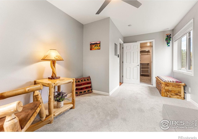 living area featuring baseboards, carpet floors, and ceiling fan