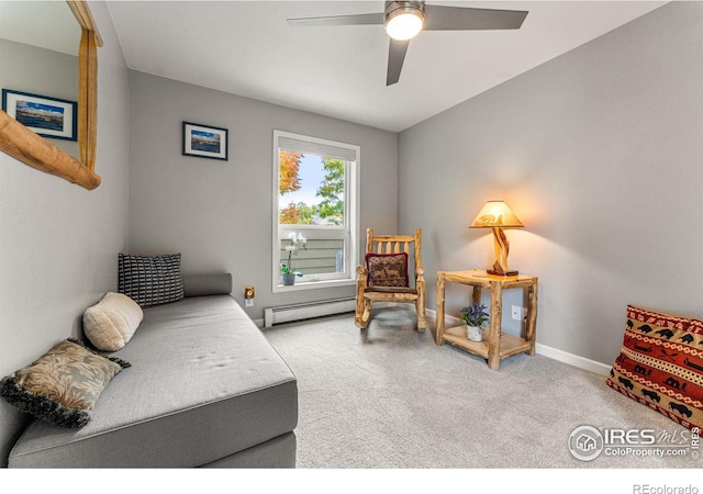 living area featuring light carpet, a baseboard radiator, and ceiling fan