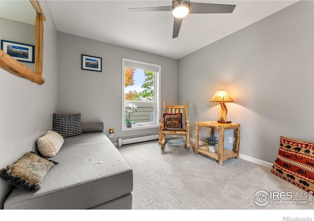 sitting room featuring a baseboard heating unit, carpet flooring, baseboards, and a ceiling fan