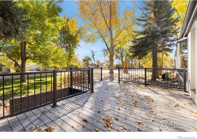 wooden terrace featuring central AC unit