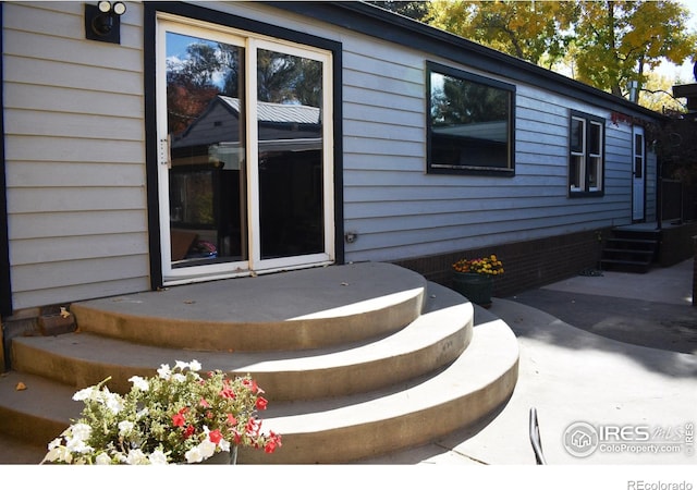 entrance to property with a patio