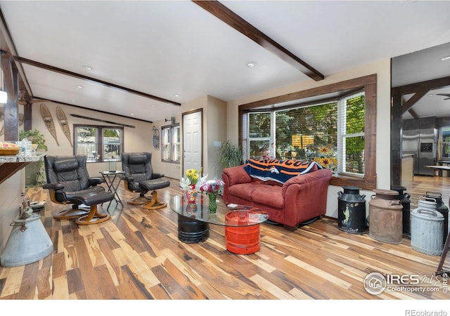 living room with beamed ceiling and wood-type flooring