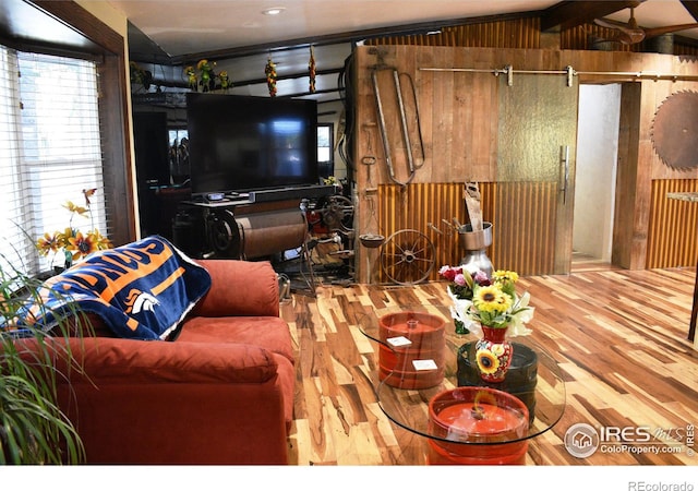 living room with wooden walls, wood-type flooring, and vaulted ceiling