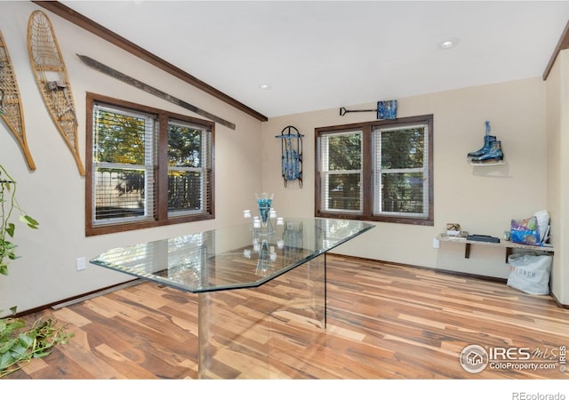 unfurnished dining area with ornamental molding and hardwood / wood-style floors