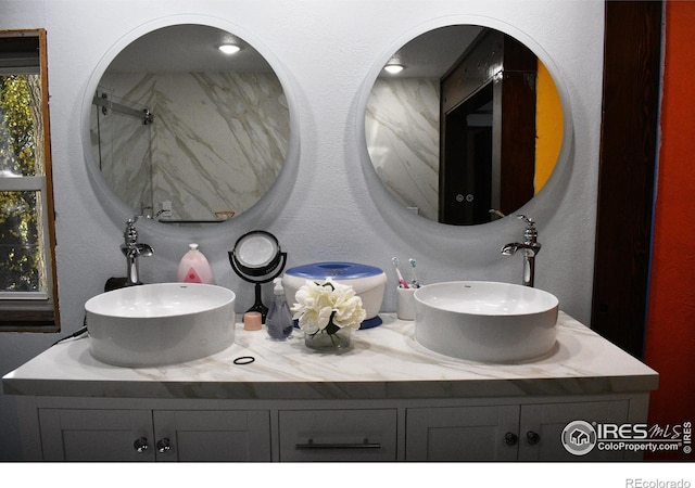 bathroom featuring vanity and a shower