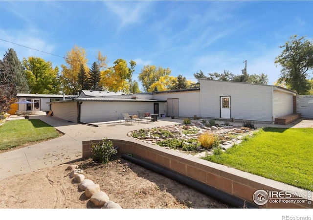 view of front of property with a patio and a front lawn