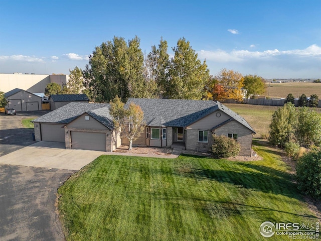 single story home featuring a front yard and a garage