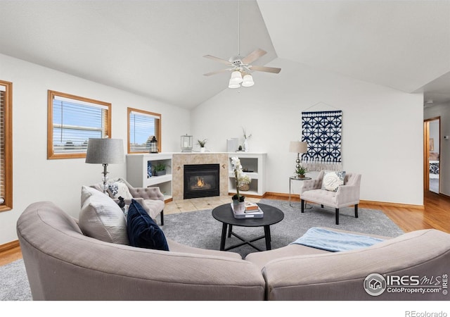 living room with light hardwood / wood-style floors, lofted ceiling, and ceiling fan