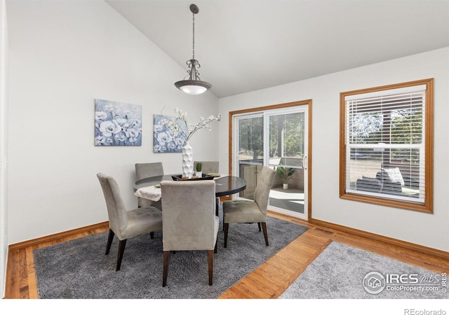 dining room with lofted ceiling and hardwood / wood-style floors