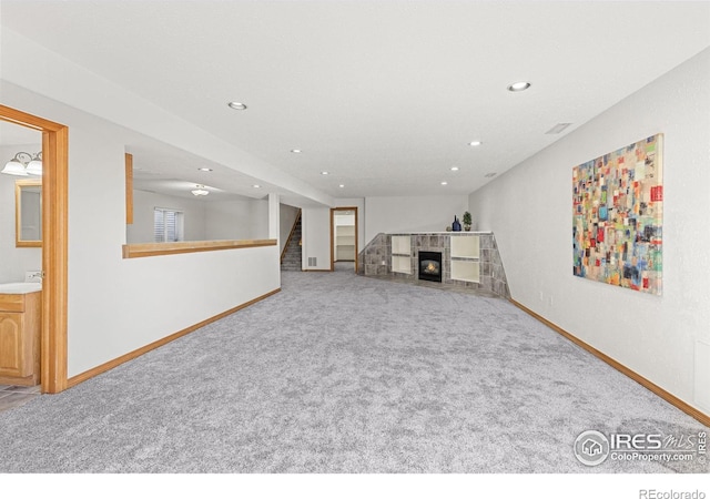 unfurnished living room featuring sink and carpet floors