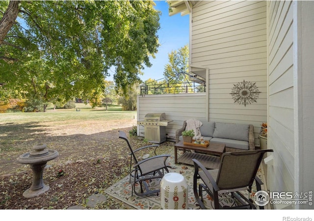 view of patio / terrace with an outdoor hangout area, grilling area, and a gazebo