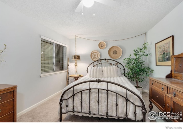 carpeted bedroom with ceiling fan and a textured ceiling