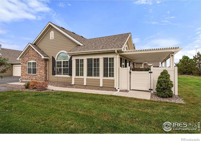 back of property featuring a yard and a pergola