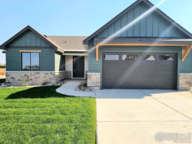 craftsman house with a front yard and a garage