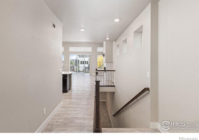 corridor featuring light hardwood / wood-style floors