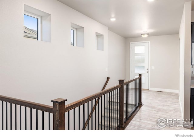 hall featuring light hardwood / wood-style floors and plenty of natural light