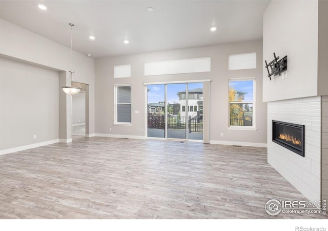 unfurnished living room with a fireplace and wood-type flooring