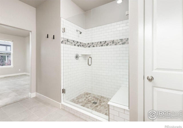 bathroom featuring a shower with door and tile patterned floors