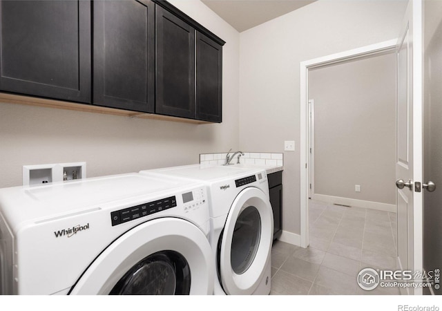 laundry area featuring sink, independent washer and dryer, cabinets, and light tile patterned floors