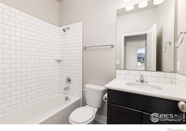 full bathroom featuring vanity, tiled shower / bath combo, and toilet