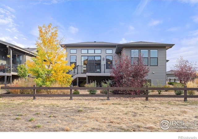 rear view of house featuring a deck