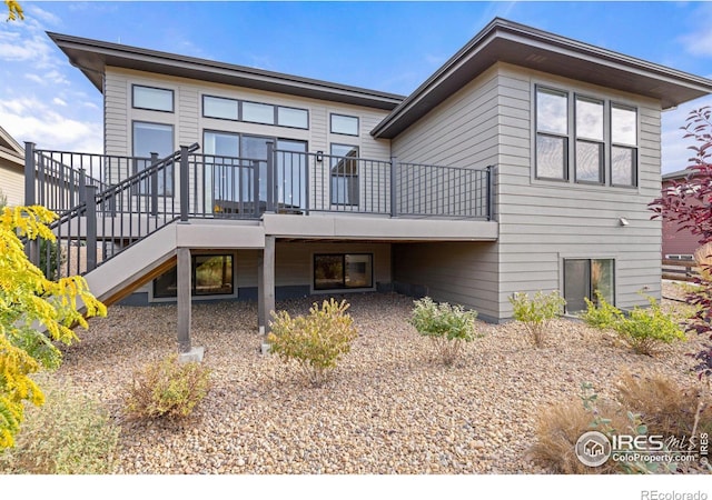 rear view of property with a wooden deck