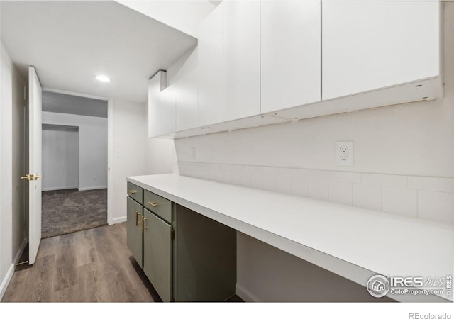 interior space with white cabinetry and light hardwood / wood-style flooring