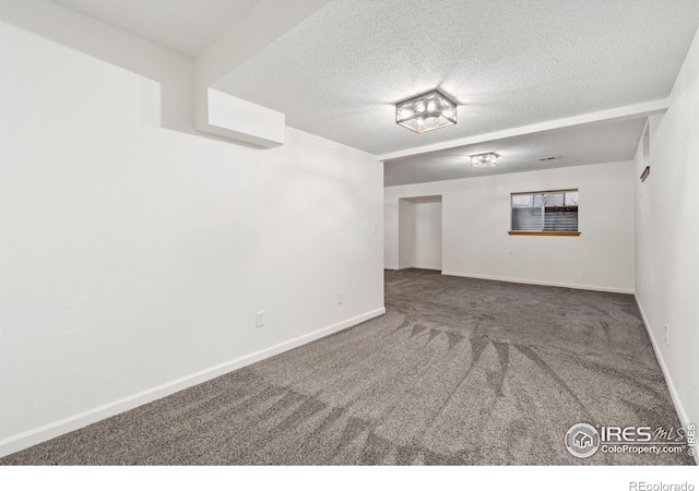 carpeted empty room with a textured ceiling