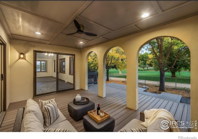 exterior space with an outdoor living space and ceiling fan