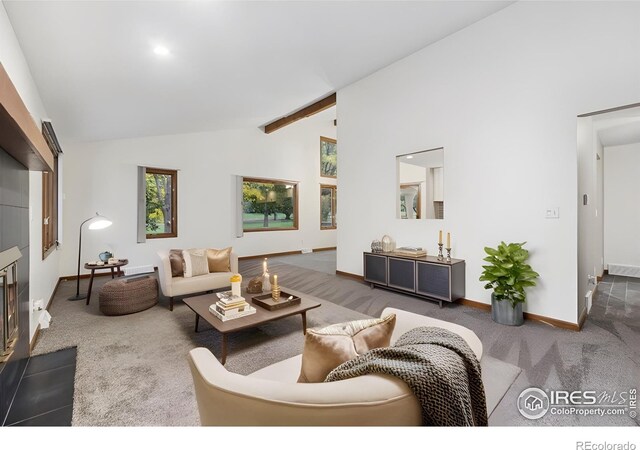 living room with dark colored carpet, high vaulted ceiling, and beamed ceiling