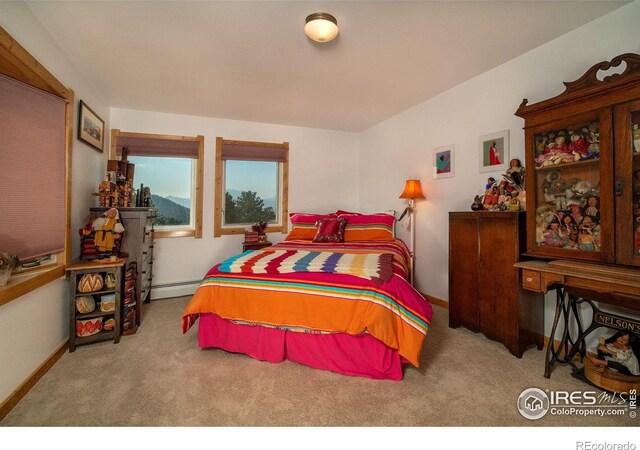 carpeted bedroom featuring baseboard heating