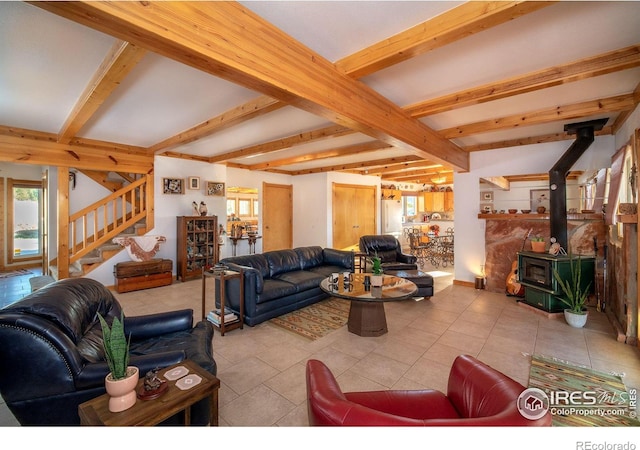 tiled living room with a wood stove and beam ceiling