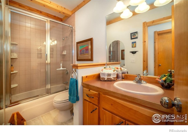 full bathroom featuring toilet, enclosed tub / shower combo, and vanity