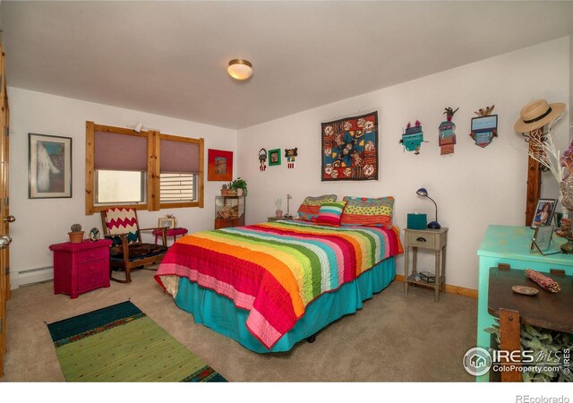 carpeted bedroom featuring a baseboard heating unit