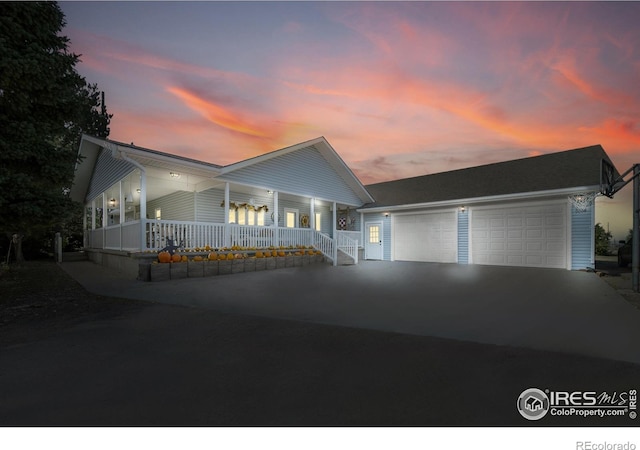 view of front facade featuring a garage and a porch