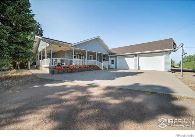 view of front of property with covered porch and a garage