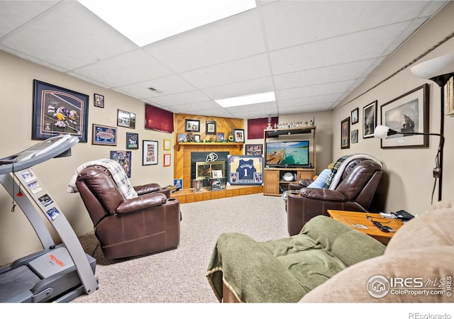 carpeted living room featuring a paneled ceiling