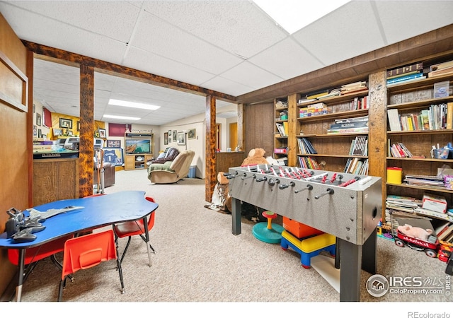 game room featuring a drop ceiling and carpet flooring