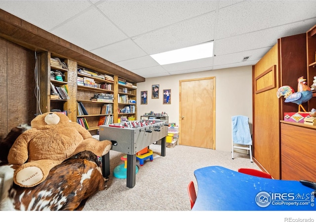 rec room with a drop ceiling and carpet floors