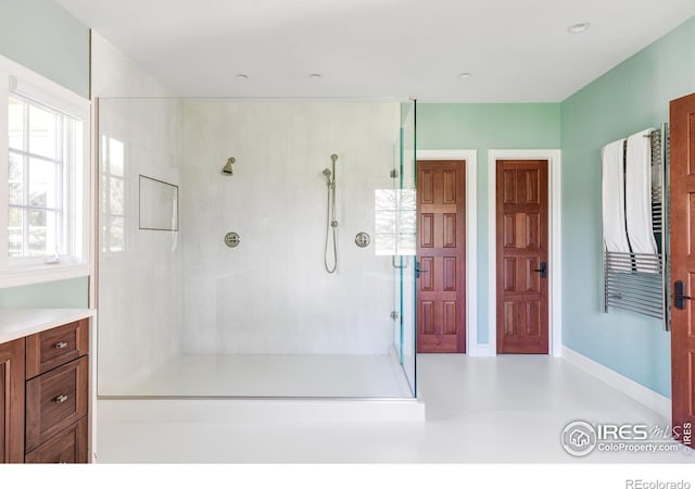 bathroom featuring vanity and a shower with shower door