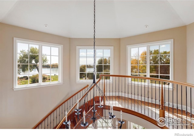 staircase with a water view and plenty of natural light