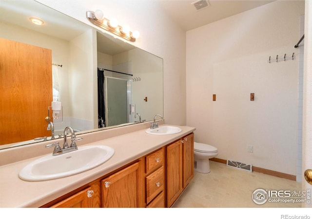 bathroom with toilet, walk in shower, and vanity