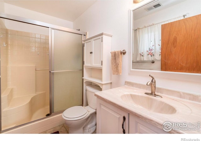 bathroom with vanity, toilet, and walk in shower