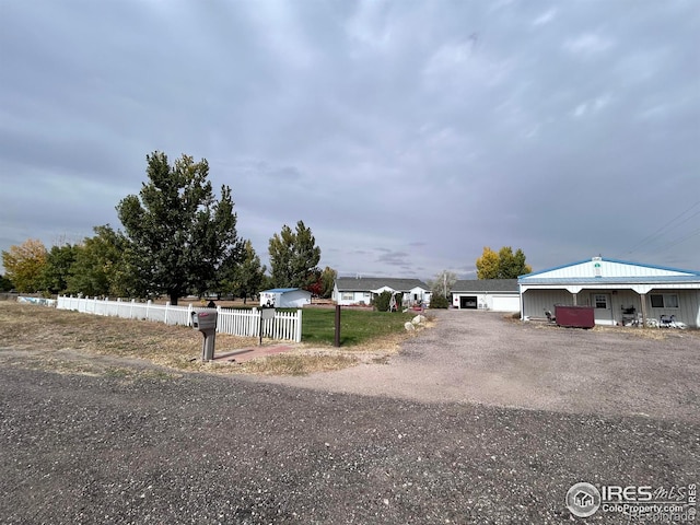 view of road with gravel driveway