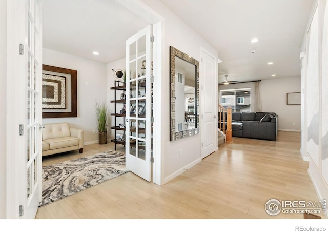 hall with french doors and light wood-type flooring