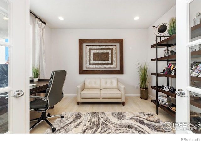 home office with light hardwood / wood-style floors