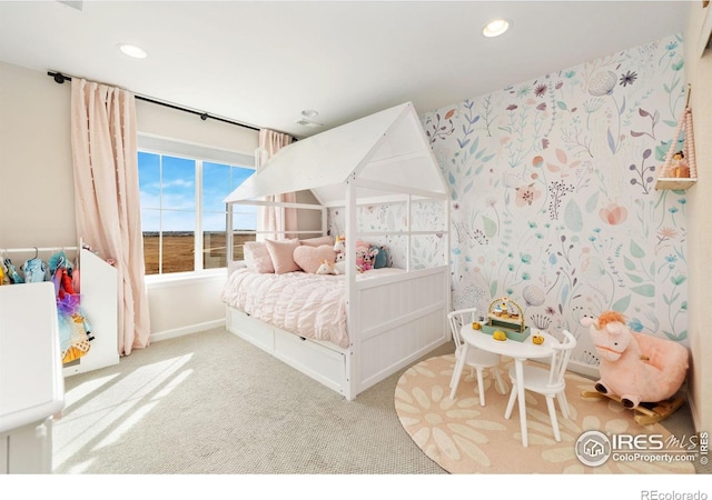 carpeted bedroom with a water view