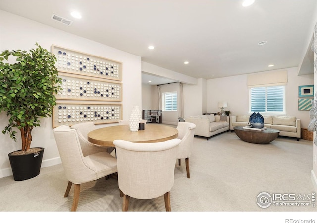 dining room featuring light carpet