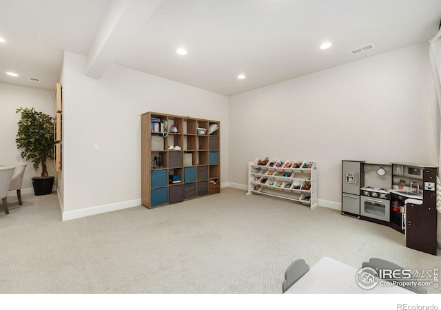 game room featuring beam ceiling and carpet flooring