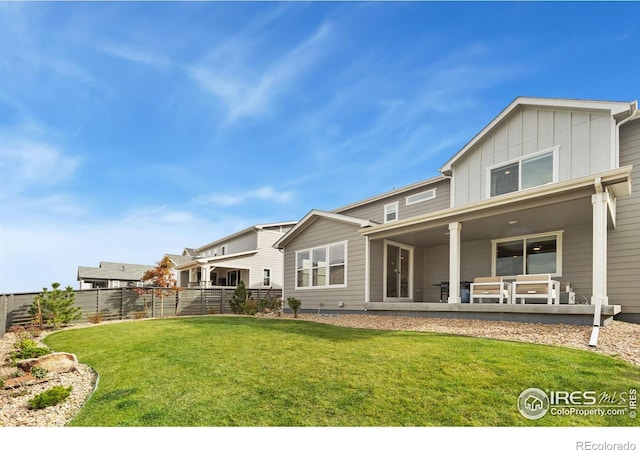 rear view of house with a yard and a patio area